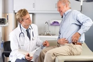 Senior discussing hip replacement surgery with his physician