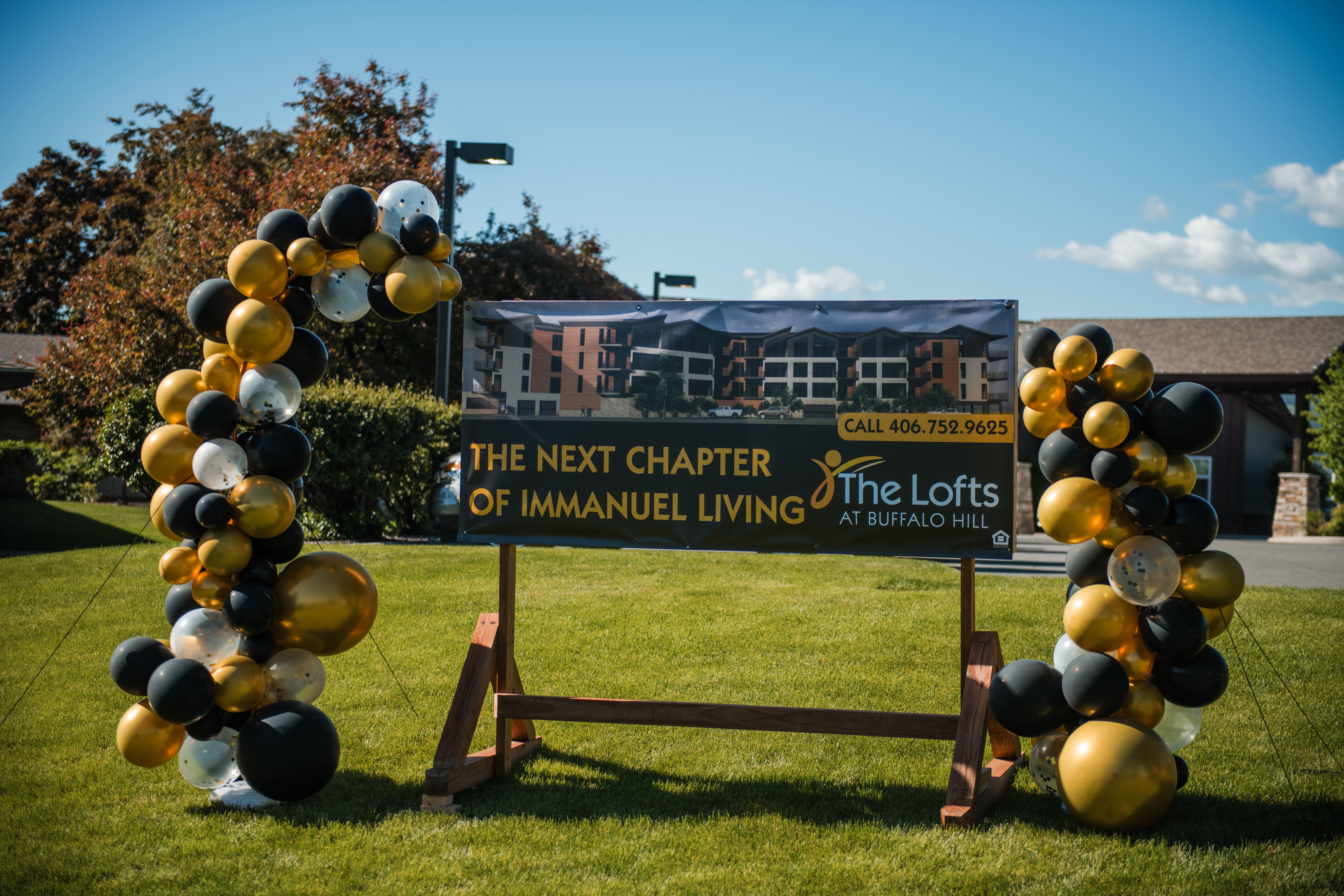 Ceremonial groundbreaking banner at the future location of The Lofts, a new independent senior living option in Kalispell, Montana.