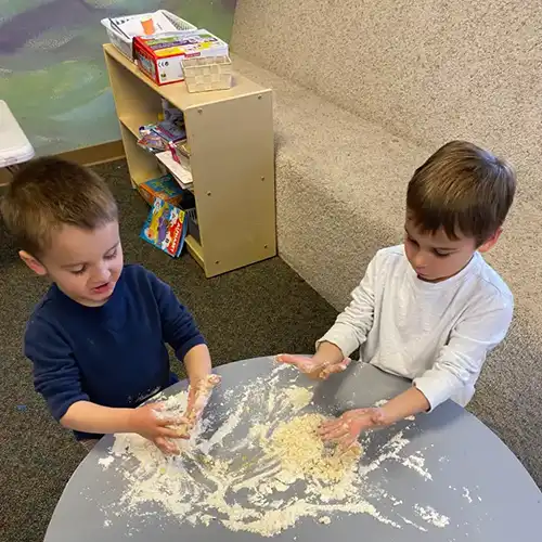 Growing Roots Early Learning Center students with a dough project.